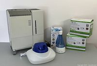 Overall image showing all three humidifiers together with filter packs, demonstrating lot contents and included accessories