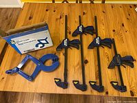 Photo showing the clamp and packaging from an angle highlighting the clamp size and brand information on the box.