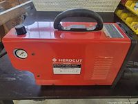 Front side of plasma cutter showing housing and logo