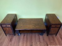 Front view of coffee table flanked by two matching end tables
