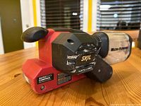 Front-left angle showing SKIL branding, micro-filtration dust canister, and auto track control label.