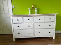 Front view of dresser showing all drawers and knobs