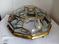 Dome-shaped hanging lamp with brass frame and bevelled glass panels on white surface. Shows condition and components.