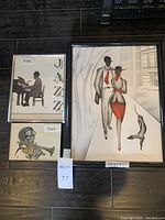 Three framed jazz-themed art pieces grouped, showing size labels and signatures.