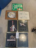 Lot of six framed art prints laid out on floor; includes billiards, vintage cars, world map, and four LA Games 1984 sports prints.