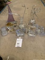 All 9 glass and crystal decorative pieces arranged on a surface showing size and variety
