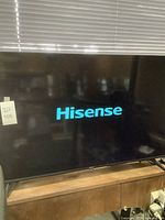 Front view of the powered on Hisense 47-inch TV displaying the Hisense logo.