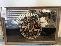 Photo showing the full bar mirror with wooden frame and Tullamore Dew branding including dimensions tag.