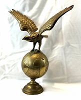 Front view of the brass eagle globe sculpture
