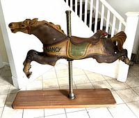 Full side view of carousel horse mounted on oak base