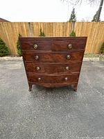 Front view showing four drawers and original brass ring pulls