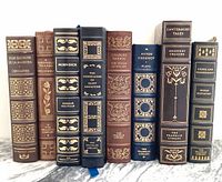 Front view of all eight book spines showing title and gold foil detailing.