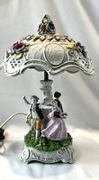 Front three-quarter view of porcelain figural lamp with lithophane shade