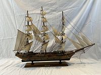 Front side view of the wooden model ship with full sails and rigging visible, displayed against a neutral background.