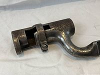 Close-up of the socket and clamp of the bayonet showing metal wear and patina