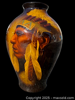 Front view of ceramic vase showing painted profile of Sioux chief with feather headdress against brown and yellow glaze.