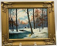 Front view of original oil painting winter landscape with gold-tone ornate frame on clear display stand.