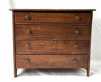 Front view of the closed dresser showing all four drawers and overall condition