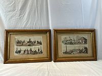 Two framed William Heath marine prints side by side on table