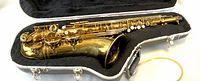 Alto saxophone in opened hard case, showing lacquer and key layout