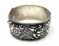 Front view showing raised floral design and twisted rope border