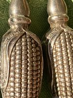 Close-up of a cornholder showing the raised corn kernel pattern and handle shape