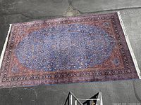 Overhead view of full rug laid on pavement showing full pattern and dimensions.