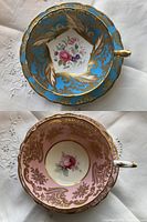 Top view photo showing robin's egg blue teacup with gold trim and floral center design along with soft pink teacup with gold trim and floral center design.