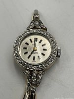 Front-facing view of watch head showing dial and diamond bezel