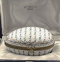 Closed porcelain box on cream satin, interior lid showing “Le Tallec Paris” stamp