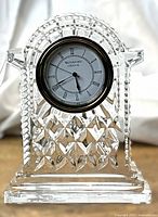 Front view of Waterford Crystal Lismore carriage clock showing cut crystal design and white clock face with Roman numerals.