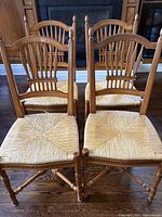 Group of four chairs front view on hardwood floor