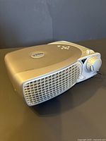 Dell 2200MP projector shown from front and side with focus dial and vent grille visible.