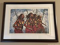 Framed print showing four African warriors holding spears with geometric background
