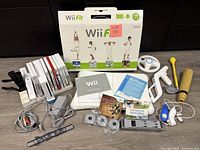 Overview of console, balance board box, game cases and various accessories