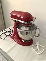 Front view of mixer with bowl and beater accessory to side