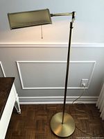 Full view of the floor lamp showing its height, base, and swing arm with rectangular shade.