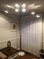 Full view of lamp showing five arched stems and marble base