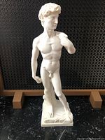 Front view of alabaster stone sculpture of David showing full figure, detailed torso, head, and base.