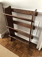 Front view of vintage 3-tier wooden bookcase showing three horizontal tiers and side panels.