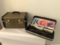 Closed McBrine vintage travel case and open case with vintage GE shoe polisher inside.