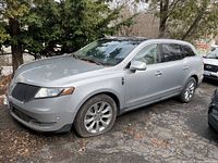 Angled front passenger-side view showing overall body and flat front tire