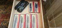 Drawer view with five Esterbrook boxed sets and a Pelikan pen case