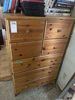 Full front view of pine dresser showing seven drawers and wood pulls.