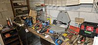 Workbench overview with assorted tools laid out under a window