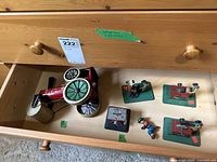 Drawer shot showing all five tin toys including steamroller and four smaller craftsman and saw items