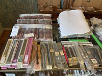 Photo showing a variety of metal and leather watch bands, some sealed in original packaging on table surface