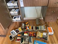 wide view of boxed and loose vehicles spread on floor under desk