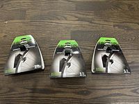 Three Slime bike hangers in original packaging showing front view with branding and installation information.