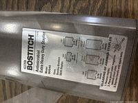 Top label of the stapler showing brand, antimicrobial feature, extra heavy duty model, effective stapling capacity and staple types compatible.